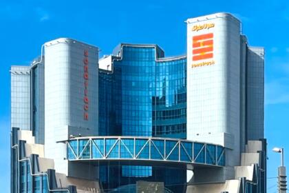 Immeuble vitré de Sonatrach à Oran, deux tours portant le nom et le logo du groupe en français et en arabe, sous un ciel bleu